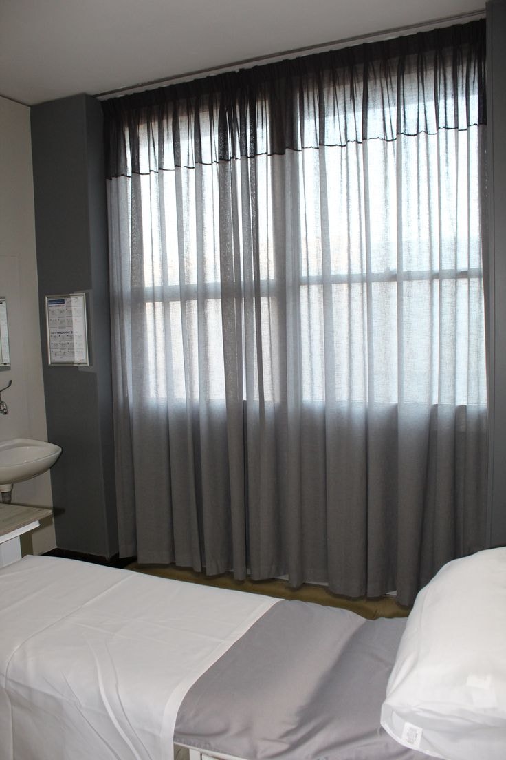 Two tone grey sheer curtains in a clinical room