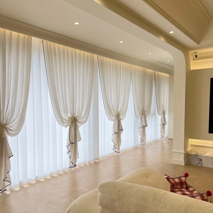 Elegant living room with floor-to-ceiling sheer French curtains