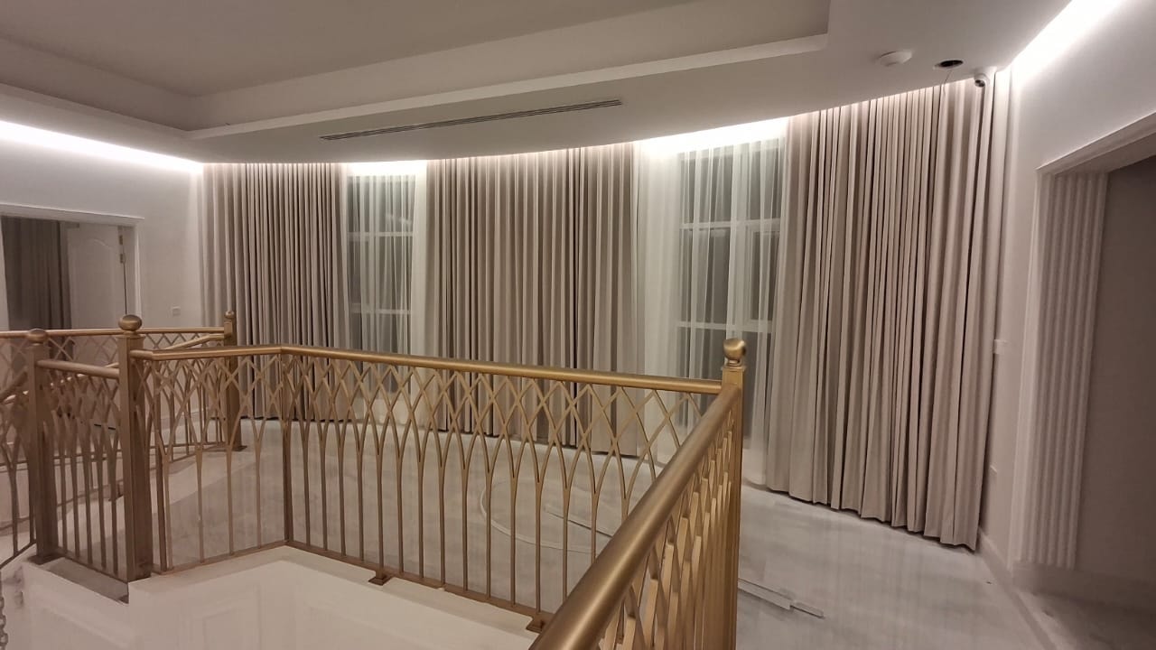 Elegant living room with layered sheer and blackout curtains